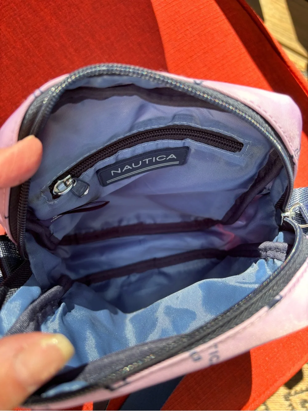 Nautica Pink Logo Print Crossbody Bag with Navy Strap and trim.